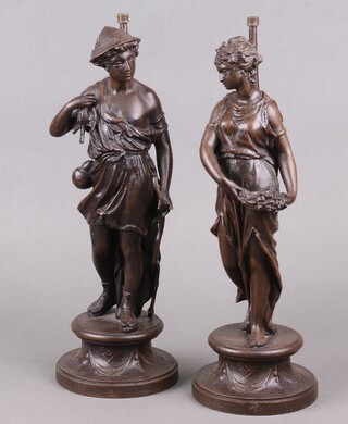 A pair of Victorian spelter figures depicting The Harvest on circular bases 38cm, drilled and converted for use as table lamps 