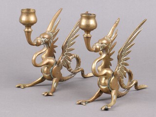 A pair of Victorian brass candlesticks in the form of seated griffins 16cm h (no sconces)