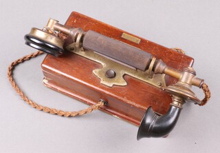 A 1920's internal wall telephone contained in a mahogany case 