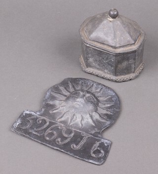 An 18th Century octagonal lead tobacco jar and cover 11cm x 12cm x 10cm and a cast lead insurance plaque marked 326916 17cm 
