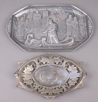 An Art Nouveau embossed metal twin handled tea tray decorated courtly scene with swan 42cm x 25cm together with a similar oval pierced plaque decorated seated children, the reverse marked 1661 31cm x 21cm 
