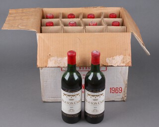 10 bottles of 1969 Mouton Cadet, shipped by Edward Young & Company (low on the neck)