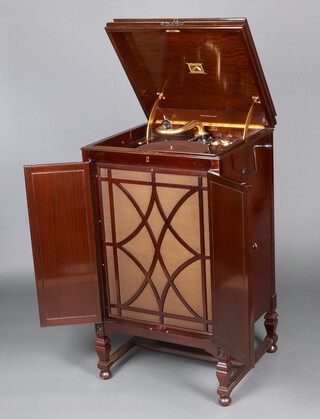 An HMV model 194 upright re-entrant tone chamber gramophone in mahogany cabinet,   fitted a 5a soundbox, gilt "Selfridge, London" retailers mark to cabinet, gilt fixtures throughout (tonearm, platter, needle cups, speed adjuster, hinges). Complete with a box of additional items including numerous tins and boxes of needles, two boxed HMV Instantaneous Speed Testers, HMV wood and green velvet cleaner, An HMV No 5A Sound Box in original box, an Auto Record cleaner in original box, an HMV No 5A Fibre Needle Cutter in box with original Instructions and a Goldring "Juwel-Electro" soundbox. The mechanism is in "working" order. Please note: we do not guarantee speed, quality or longevity of playback. 113cm h x 63cm w x 56cm d

