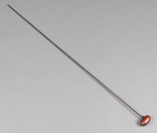 A 19th/20th Century iron straw needle with wooden handle 112cm long 