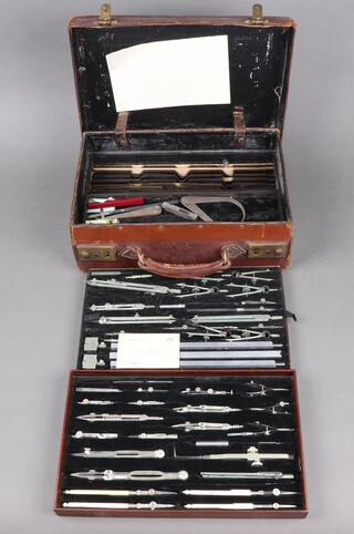 A comprehensive professional draughtsman's set with compasses, pencils, rules, contained in 3 trays and within a leather case, within the base there is the remnants of a decayed rubber, together with a business card for AAD Brown, Chief Spring Designer for Salters Scales,  some pieces with ivory handles.  With non-transferable standard ivory exemption declaration number GRQ4AURB