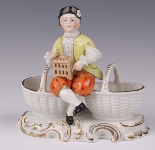 A late Dresden table salt in the form of a seated gentleman with bird cage and 2 baskets 10cm 