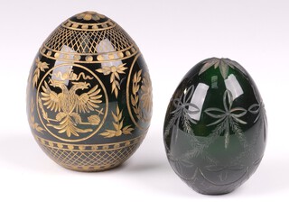 A 19th Century etched glass paperweight in the form of an egg decorated a double headed eagle and cypher 5cm together with 1 other with swag decoration 5cm 