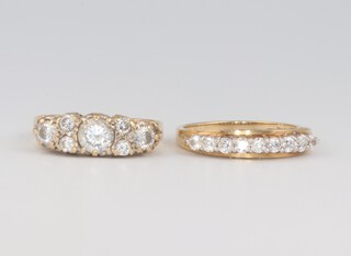 A 14ct yellow gold dress rings set 6 cubic zirconia and 1 other set 9 cubic zirconia, sizes K and J 1/2