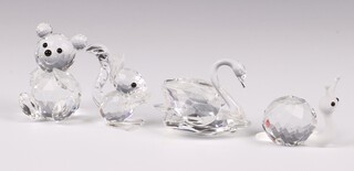 Four Swarovski Crystal figures - seated bear, swan, snail and squirrel, all boxed