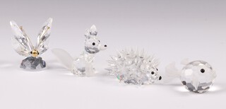 Four Swarovski Crystal figures - puffer fish 5cm, a hedgehog, dragon fly and fox, all boxed