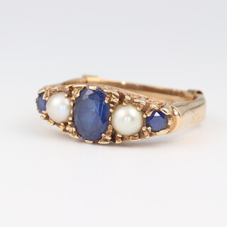 A 9ct yellow gold ring set a sapphire and demi-pearls, size R, with internal 9ct gold spacer, 4.5 grams gross 