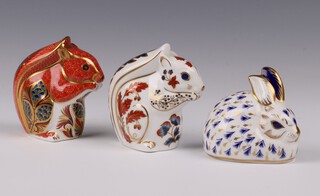 A Royal Crown Derby Imari pattern paperweight in the form of a rabbit, base with gold stopper LV 7cm, together with a squirrel LIV 8cm and red squirrel LXI both with silver stoppers 9cm, all boxed