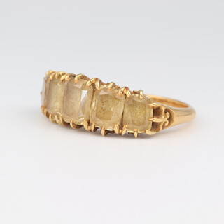 A yellow gold testing as 9ct dress ring set 5 smoky quartz, size K, 4.5 grams 