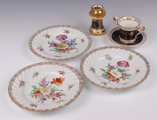 Three Dresden floral patterned plates 22cm, a cylindrical Continental night light in the form of a kettle and stand base decorated figures (in 3 sections) 10cm (gilding rubbed) and a Continental porcelain twin handled cup with matching saucer (both handles f and r, chip to top) 