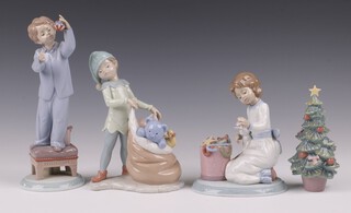 Four Lladro Christmas figures - I Love Christmas 6672, Sack of Dreams 6894, Ringing in the Season 6671 and Christmas Tree 6261 14cm
