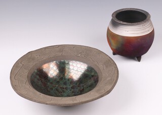 John Wheeldon, (born 1950) a studio pottery textured stoneware purple bowl with lustre decoration to the centre 27cm diam. together with a cauldron shaped vase 14cm h (chip to rim)