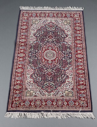 A blue, brown and white ground North West Persian floral pattern rug with central medallion within a multi row border 156cm x 94cm 