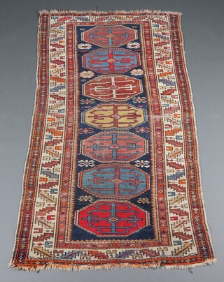 A blue and white ground Caucasian style runner with 7 octagons to the centre 195cm x 103cm 