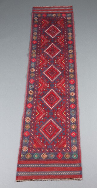 A red and blue ground Meshwani runner with 5 diamonds to the centre within a multi row border 251cm x 60cm 