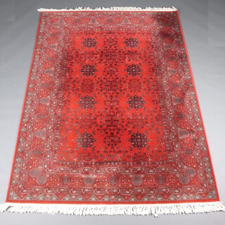 A red, white and black ground machine made Persian style rug with 2 rows of stylised medallions to the centre 237cm x 170cm 