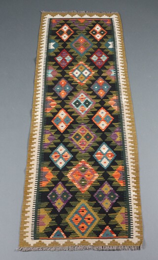 A black, green and white ground Maimana Kilim runner with overall diamond design 198cm x 168cm 