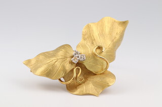 Andrew Grima, an 18ct yellow gold brooch in the form of a leaf set 3 diamonds, the reverse marked 750 Grima 18, 17.75 grams gross, complete with original presentation case 