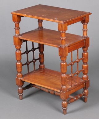 An Art Nouveau oak Liberty style rectangular 3 tier what-not, the tiers supported by turned and block supports and with lattice work panels to the sides, raised on an H framed stretcher and bun feet 81cm h x 57cm w x 37cm d 
