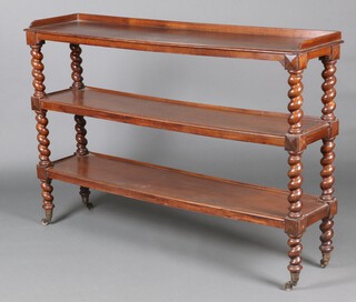 A Victorian oak 3 tier buffet with raised back, with spiral turned supports, raised on brass caps and casters 110cm h x 162cm w x 38cm d 