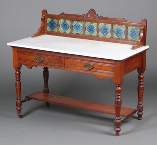 A Victorian walnut wash stand with tiled splash back and white veined marble top, the base fitted 2 drawers with under tier, raised on turned supports 106cm h x 122cm w x 62cm d 