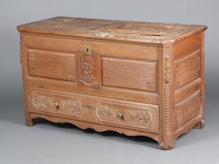 An 18th Century Continental carved oak mule chest with hinged lid, the front and sides carved flowers, the base fitted a drawer 79cm h x 137cm w x 51cm d 