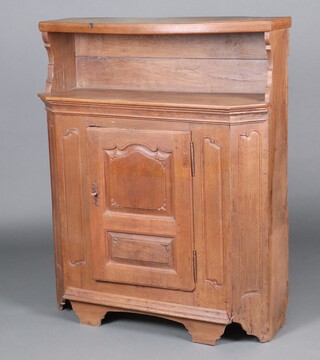 An 18th Century carved oak side cabinet with raised back above recess, the base enclosed by a panelled door, raised on bracket feet 137cm h x 111cm w x 35cm d 