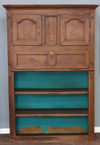 An 18th Century Continental inlaid oak cabinet with moulded cornice, the upper section enclosed by a pair of panelled doors (locked), inlaid with a bird and branch, monogrammed MW 1833, the fall front inlaid 2 stars with recess beneath fitted 2 shelves 205cm h x 138cm 