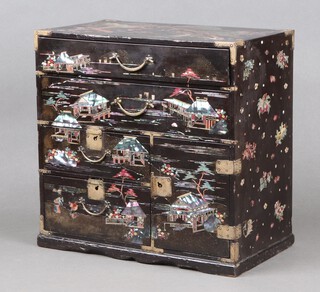 A Japanese black lacquered table top cabinet, inlaid mother of pearl decorated buildings,  fitted 2 long above 2 short drawers with cupboard fitted 3 short drawers enclosed by a panelled door 33cm h x 33cm w x 20cm d 