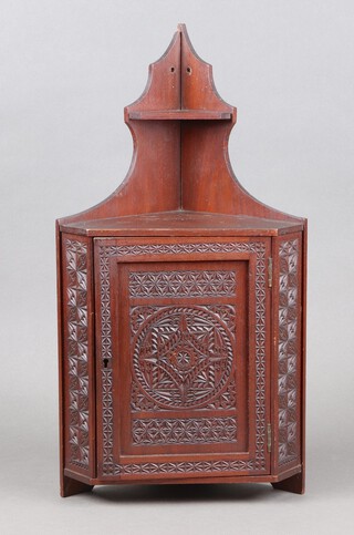 A Victorian carved mahogany corner cabinet enclosed by a panelled door 85cm h x 28cm w x 20cm d, the interior marked From W M Foster, Cabinet Makers and Joiners Haywards Heath Sussex 