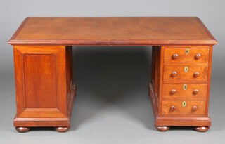 L M Emedmon Calcutta, an Indian hardwood kneehole desk with writing surface to the centre, 1 pedestal fitted 4 drawers, the other fitted a cupboard, raised on bun feet 75cm h x 165cm w x 81cm d 