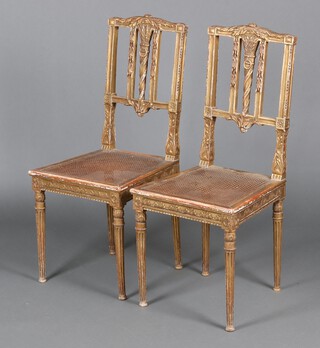 A pair of 19th Century Continental gilt painted stick and rail back salon chairs with woven cane seats, the backs decorated a flaming torch, on square supports 99cm h x 43cm w x 43cm d 