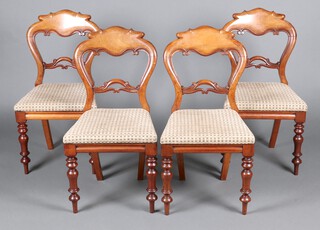 A set of 4 Victorian carved walnut spoon back chairs with pierced mid rails and drop in seats, raised on turned supports 89cm h x 44cm x 40cm 