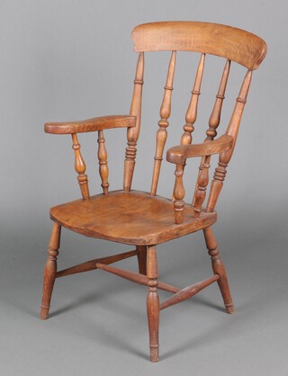 A 19th Century elm and beech Windsor stick and rail back kitchen carver chair with solid seat, raised on turned supports with H framed stretcher 97cm h x 58cm w x 53cm d 