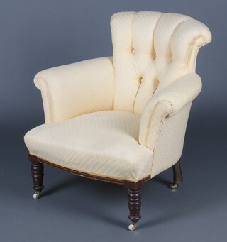 A Victorian armchair upholstered in yellow buttoned material, raised on turned feet with ceramic casters 78cm h x 77cm w 