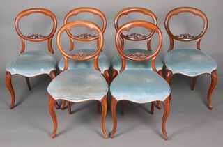 A set of 6 Victorian carved walnut balloon back dining chairs with pierced mid rails and over stuffed seats of serpentine outline, raised on cabriole supports 85cm h x 45cm w x 41cm d 