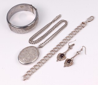 A silver curb link bracelet 20cm, an engraved hollow silver bangle, an oval engraved silver locket on a fine chain and a pair of unmarked silver Art Nouveau style drop earrings set cabochon stones 95 grams 