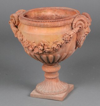 An Adams style terracotta finished twin handled urn with floral swag decoration 46cm h 