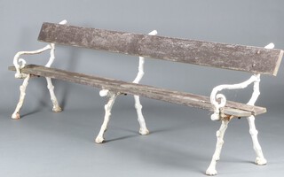 A Victorian railway station bench, raised on 3 rustic cast iron supports 82cm h x 300cm w x 50cm d 