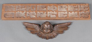 A rectangular wooden "ginger bread mould" 75cm x 15cm together with a resin wall plaque in the form of a cherubs head 42cm 