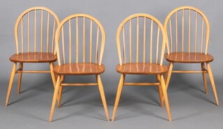 A set of 4 Ercol light elm and beech stick back dining chairs, on turned outswept supports 81cm h x 42cm w x 41cm d (varnished, rubbing to high points)