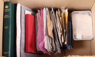 A Windsor stamp album, a red stamp album and a collection of various first day covers 