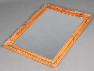 A rectangular plate mirror contained in a carved pine frame 94cm x 68cm 