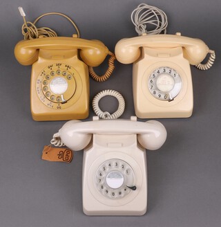 A 1980's ivory coloured dial telephone, a cream ditto and 1 other 