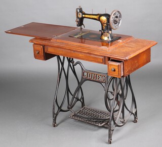 A Jones treadle operated sewing machine no.136083 on an iron stand 73cm h x 93cm w x 46cm d