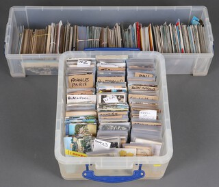 A large collection of black and white and coloured postcards including English resorts, America, South Africa and a collection of coloured postcards, contained in 2 plastic boxes 
